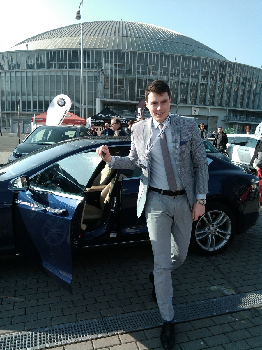 Guy stepping out of the Tesla